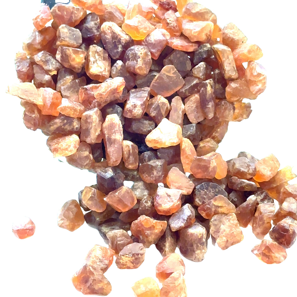 Raw Spessartine Garnet Gemstone grouping on white center overview