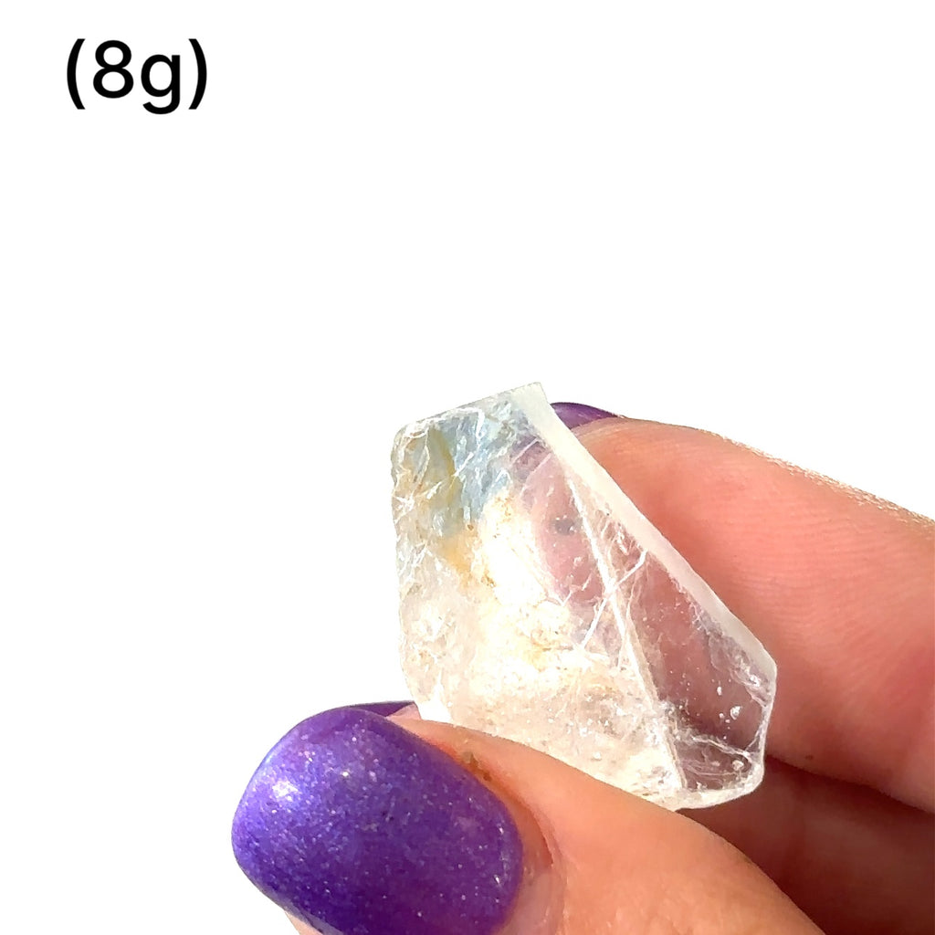 Raw Topaz stone for Crown and Solar Plexus chakra alignment grouping of gemstones (8g)  in hand to show a close-up overview