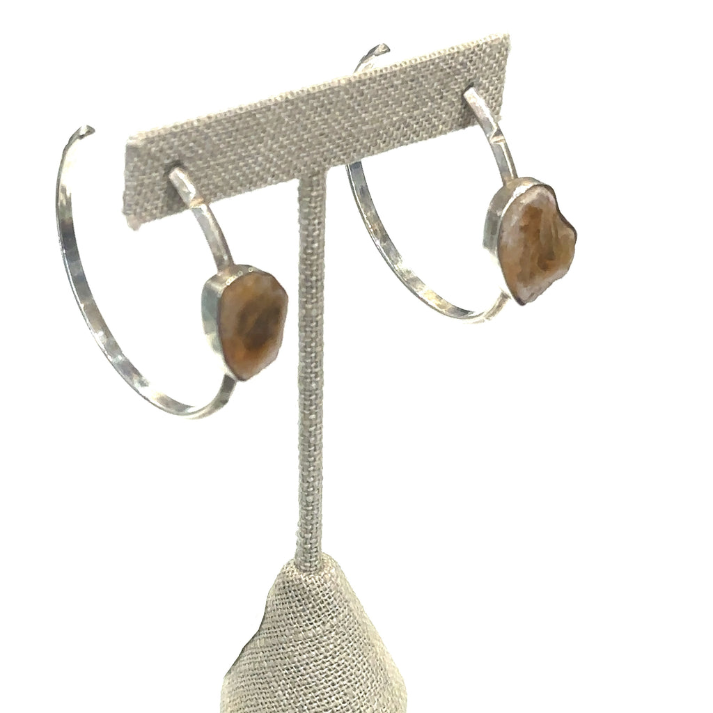 Raw slice citrine hoop studs, 1.75 inch diameter on white on earing tree for close up view