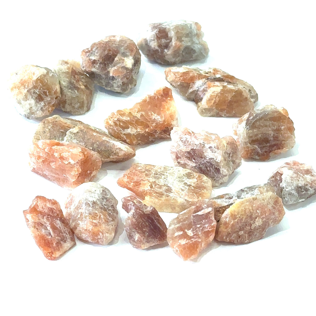 Raw sunstone stone for chakra balancing and meditation on white center overview