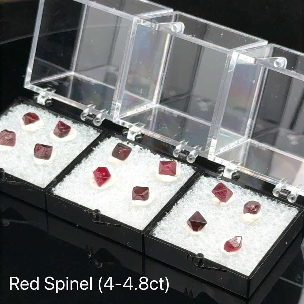 Red Spinel Raw Gemstone Crystals multiple boxes closeup Frontal