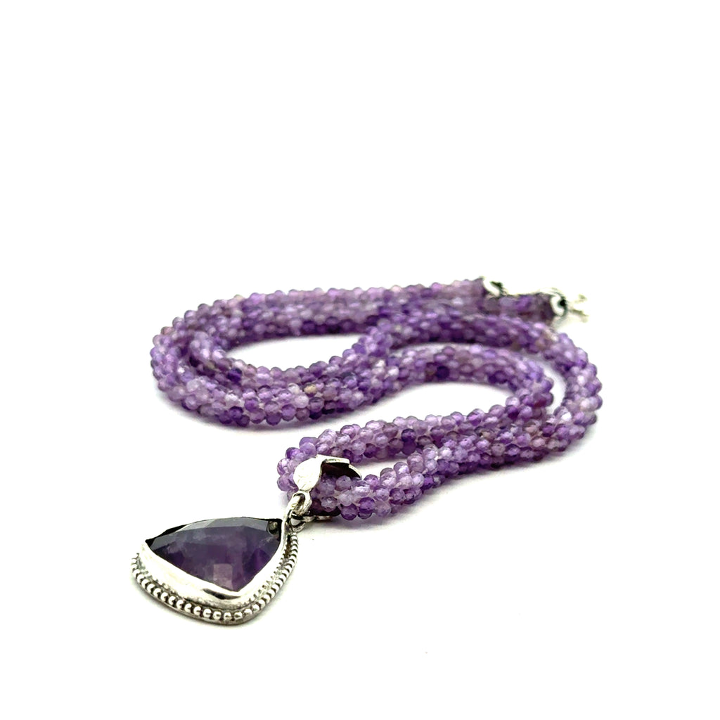 Reiki jewelry in Boston handmade with ethically sourced amethyst gemstones Crocheted Necklace with Pendant on white right side view 
