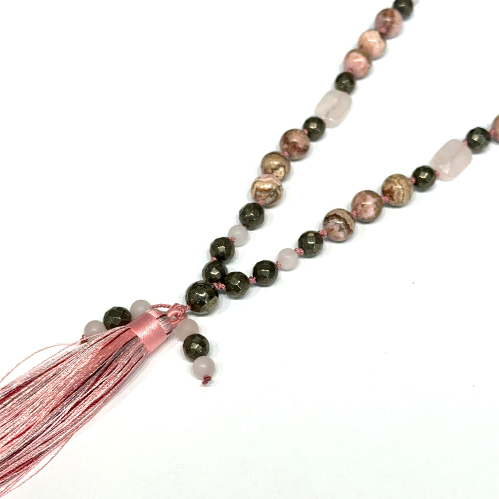 Rhodochrosite, Rose Quartz & Pyrite Mala Necklace on white long diagonal  overview
