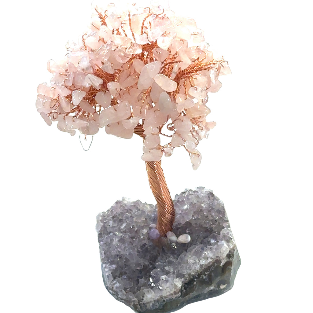 Rose Quartz Gemstone tree placed on an altar for home décor and energy healing. On a white background, front overview.