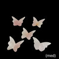 Rose Quartz butterfly-shaped crystals (med) on a black background, front view.