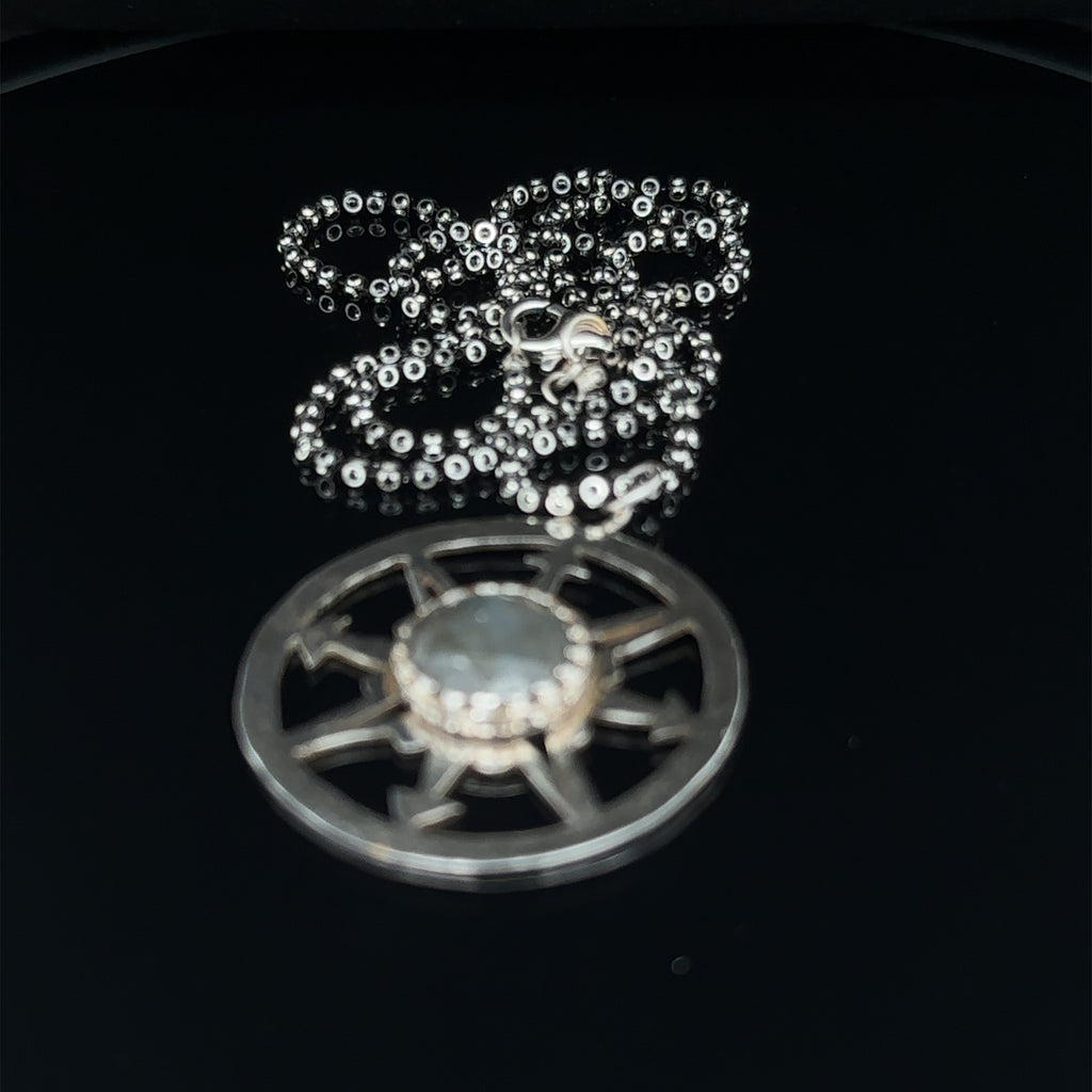 Rose‑cut Labradorite pendant in sterling silver compass design, one‑of‑a‑kind jewelry on black long overview