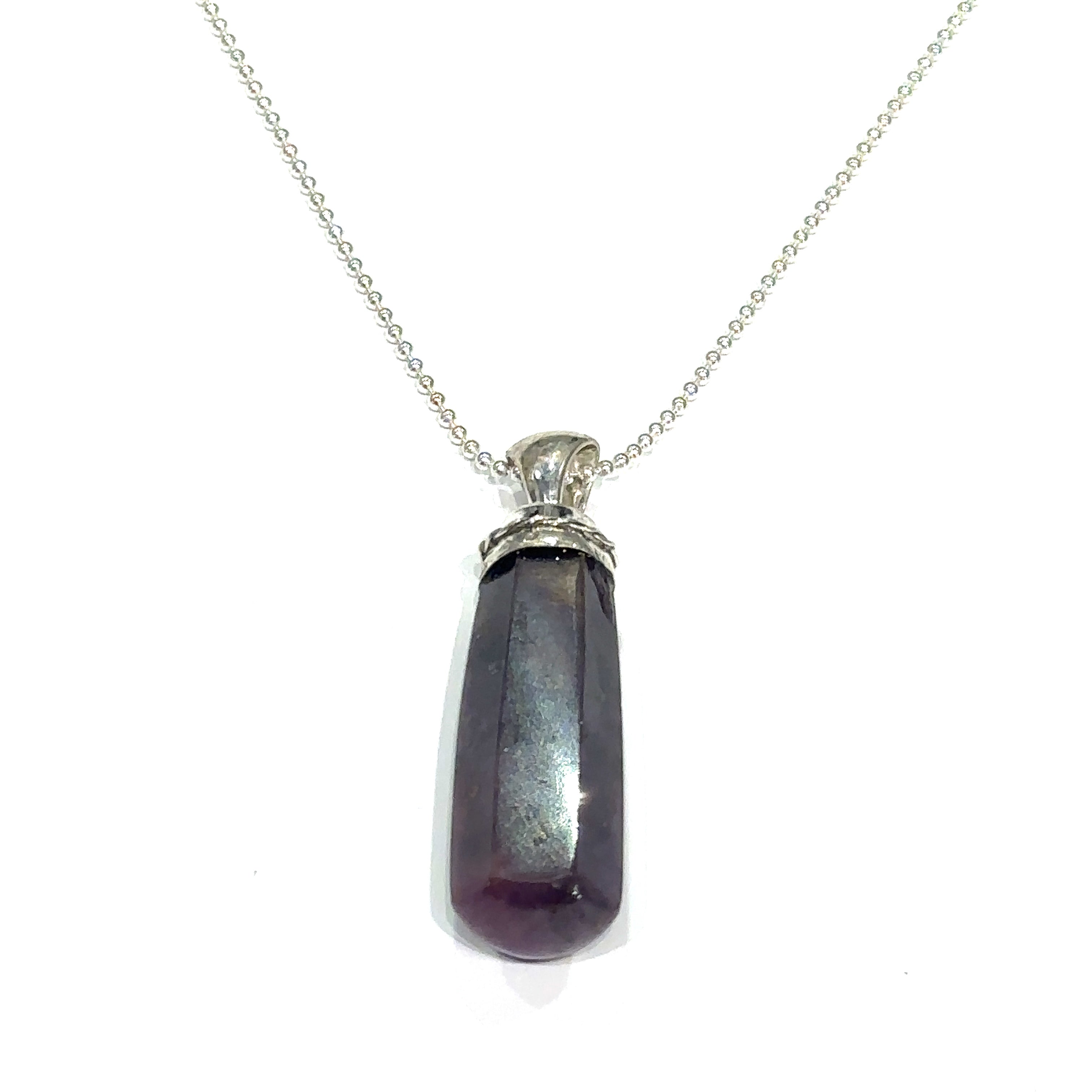 Ruby crystal point pendant in sterling silver bezel cap on white hanging overview