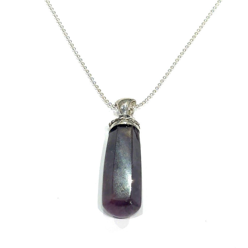 Ruby crystal point pendant in sterling silver bezel cap on white hanging overview