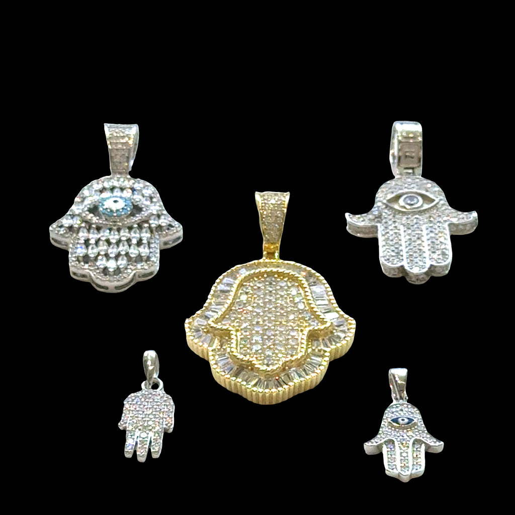 Set of Hamsa hand pendants in various designs and colors on a black background, front overview.