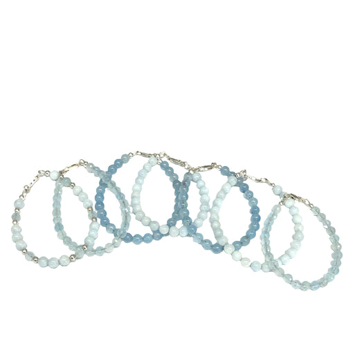 Set of five Aquamarine gemstone beaded bracelets in various shades of blue on a white background front overview. 