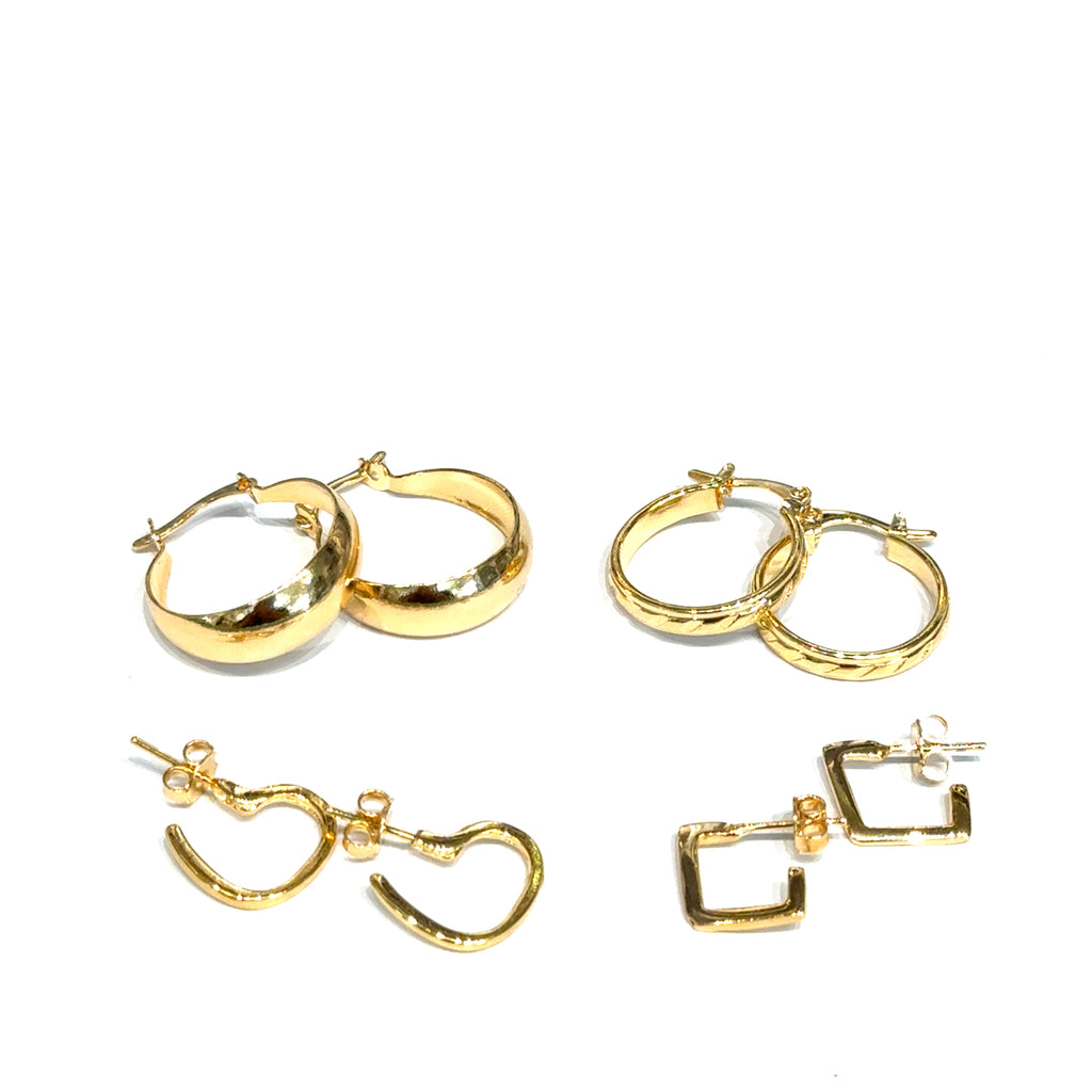 Set of four different gold hoop earrings on a white background, front overview. 