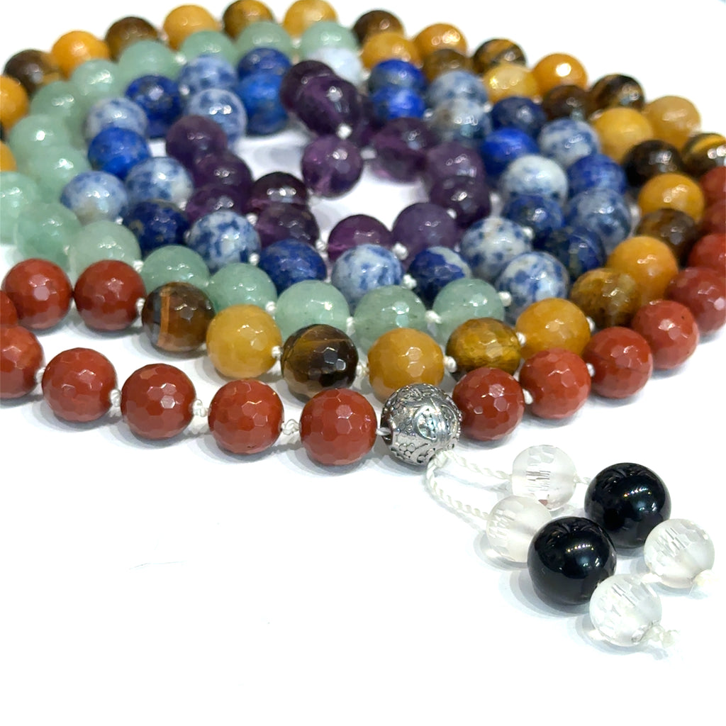 Seven Chakra Mala Necklace on white spiral  front close up overview