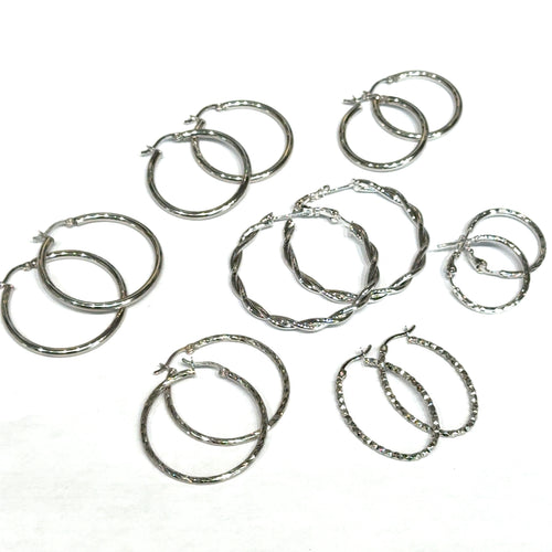 Seven sets of silver hoop earrings on a white background, front overview.