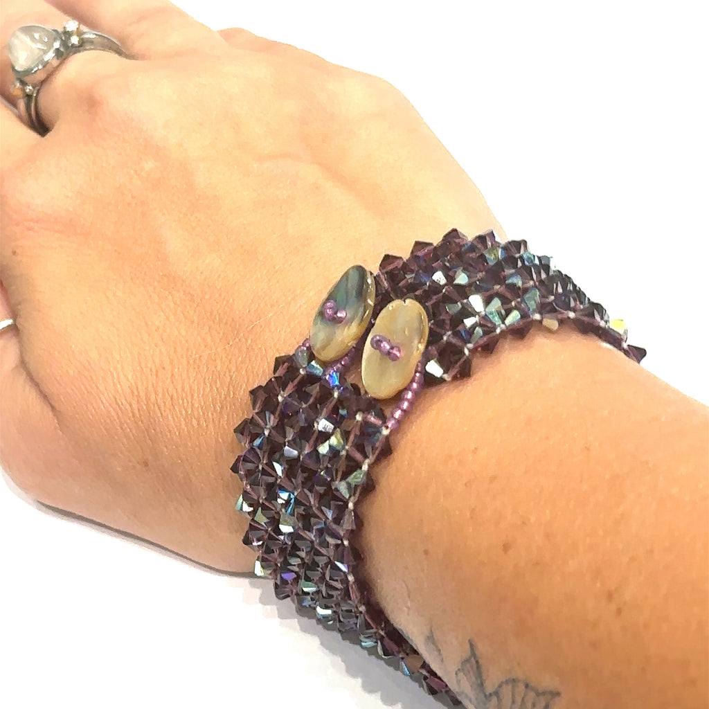 Sparkling Swarovski crystal bracelet with iridescent Abalone shell button accent on white and on wrist view