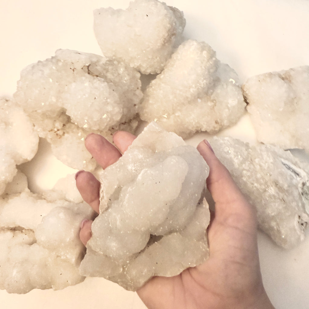 Spirit Quartz grouping for Spirit Quartz bucket on white in hand view