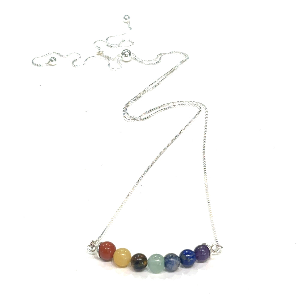  Spiritual chakra pendant necklace for meditation and mindfulness on white hanging front overview