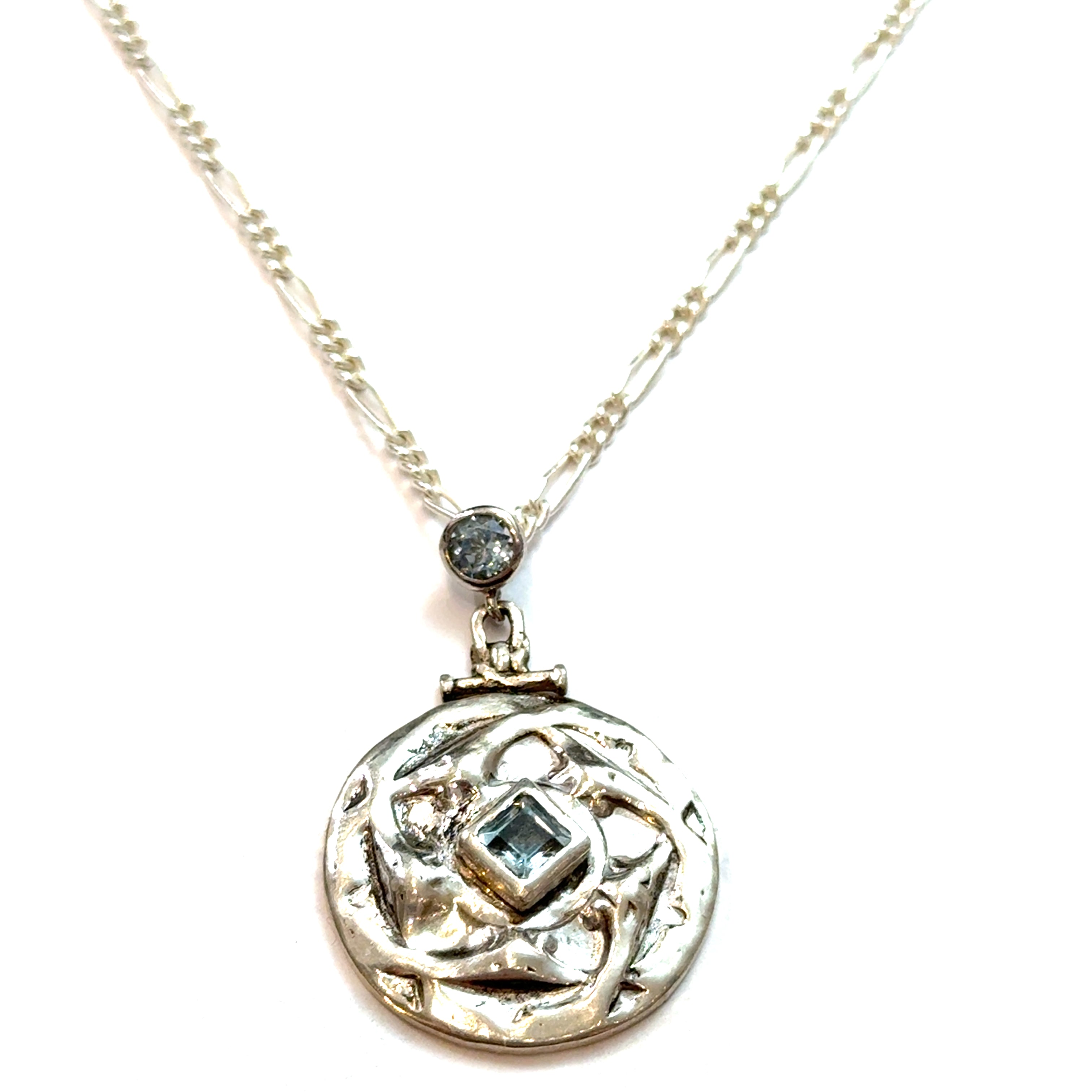 Sterling Silver Blue Topaz Pendant Necklace on white center close up hanging  overview