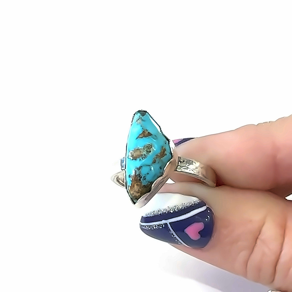 Sterling Silver Turquoise Ring on white in finger tips front center overview