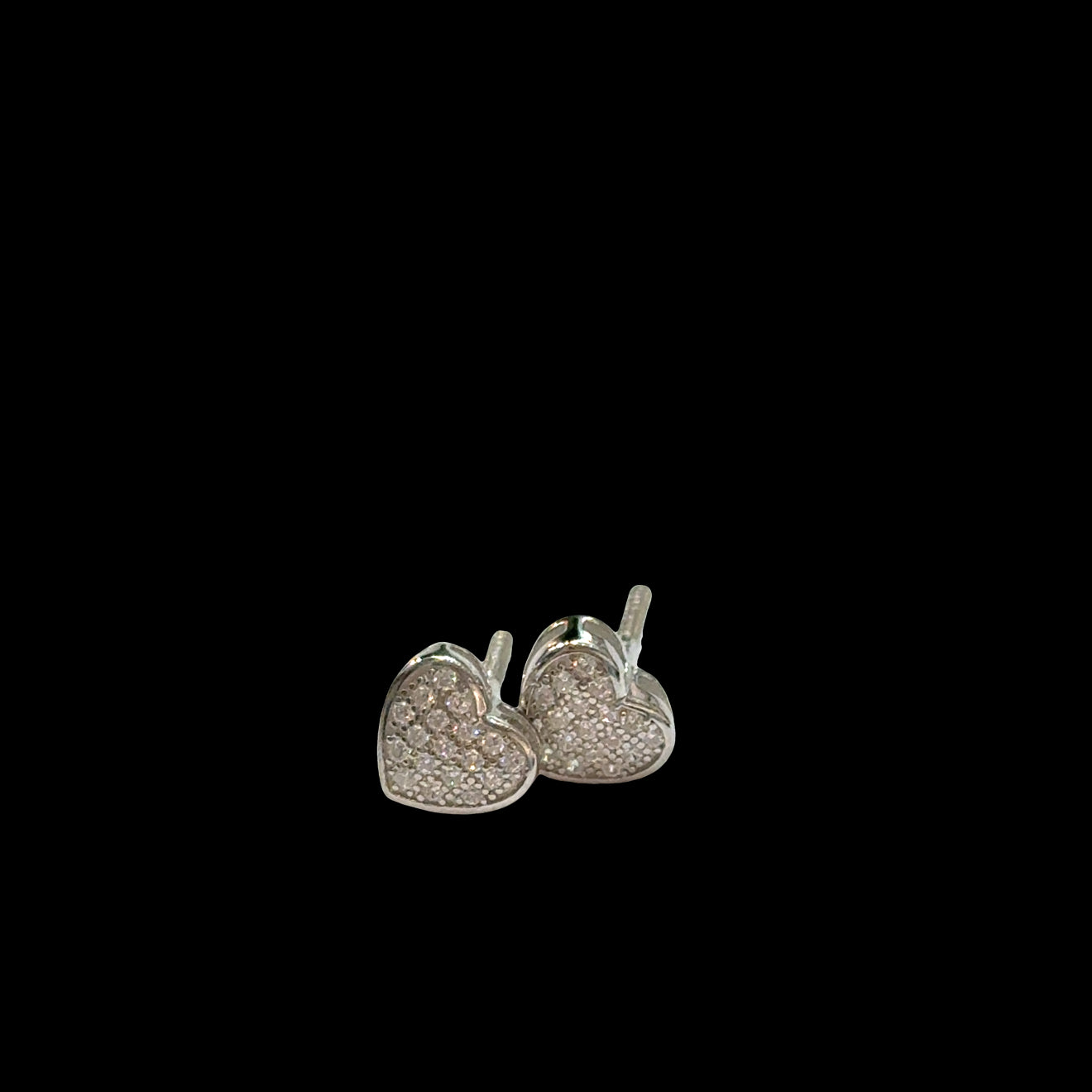 Sterling Silver heart-shaped earrings with CZ's pavé on a black background, front overview