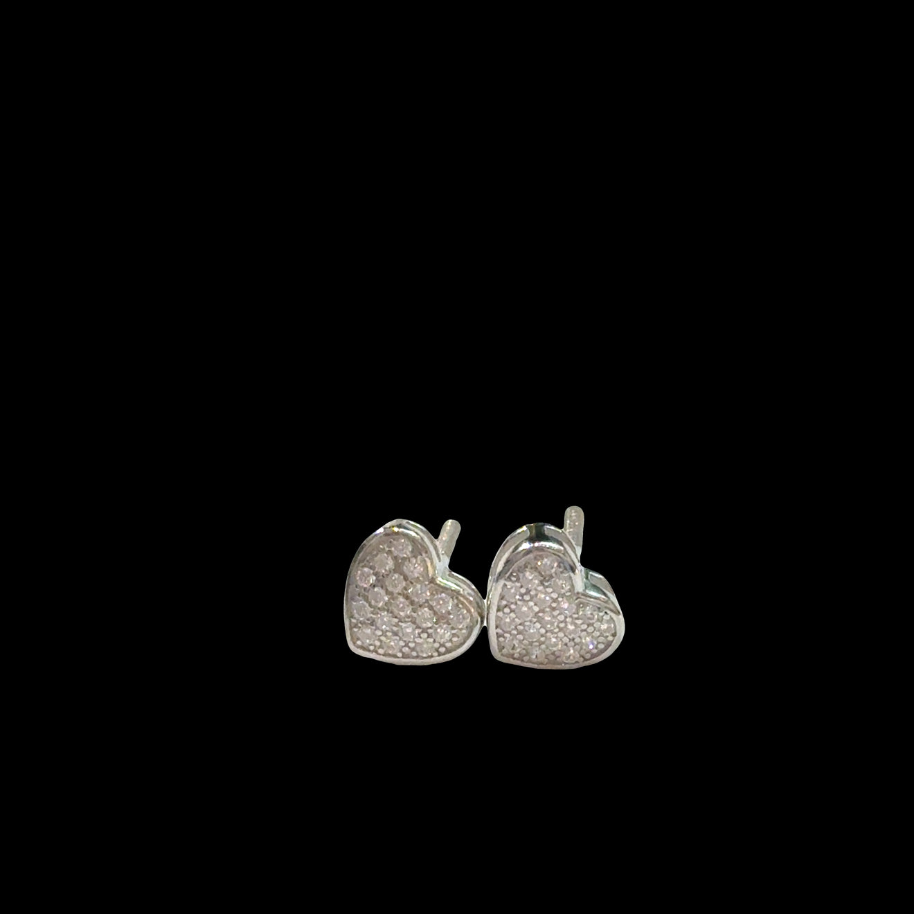 Sterling Silver heart-shaped earrings with CZ pavé on a black background, front view