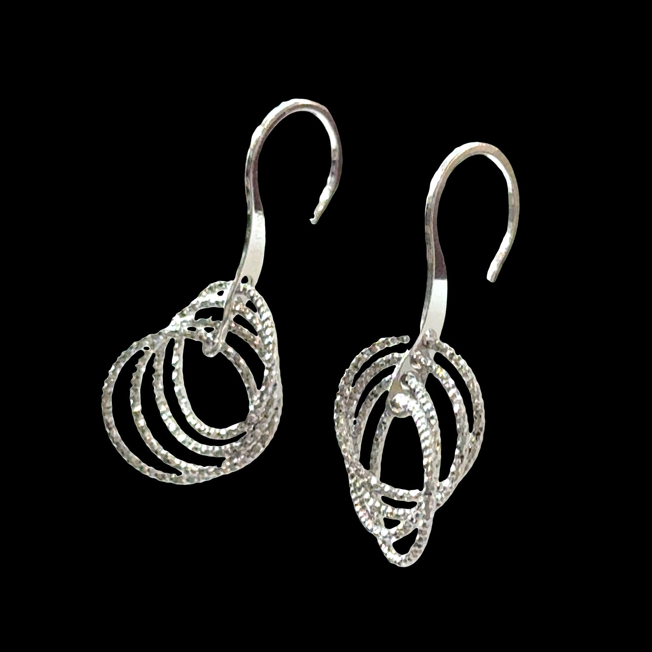 Sterling silver diamond-cut circle dangle earrings with four cascading circles and fishhook on a black background, front overview. 