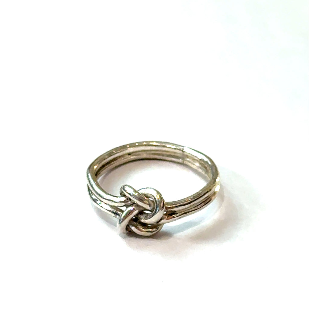 Sterling silver double knot ring handcrafted by Ivy Rose on a white background  front, close up overview. 