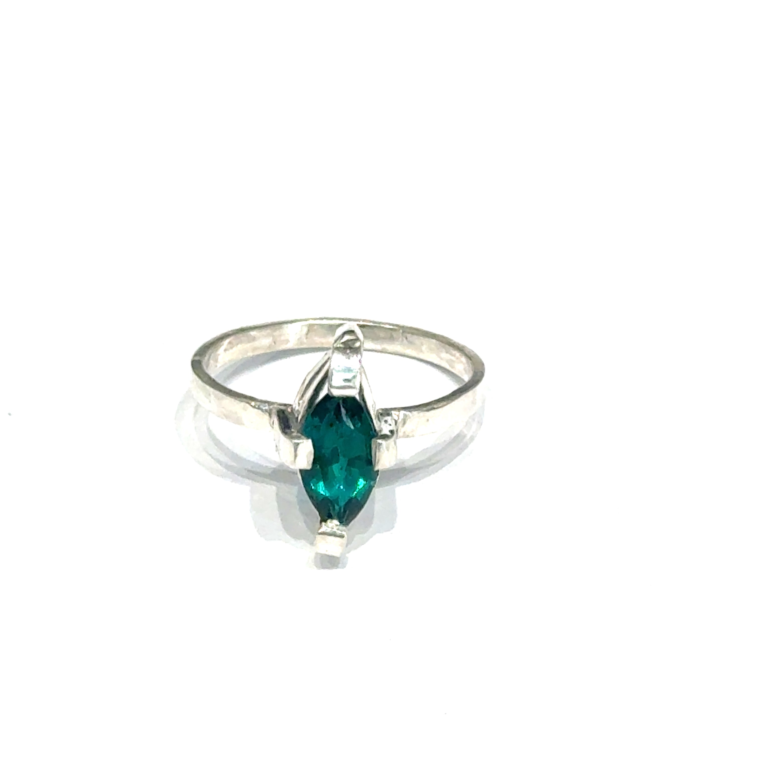 Sterling silver ring with faceted marquis emerald gemstone on a white background front, close up view.