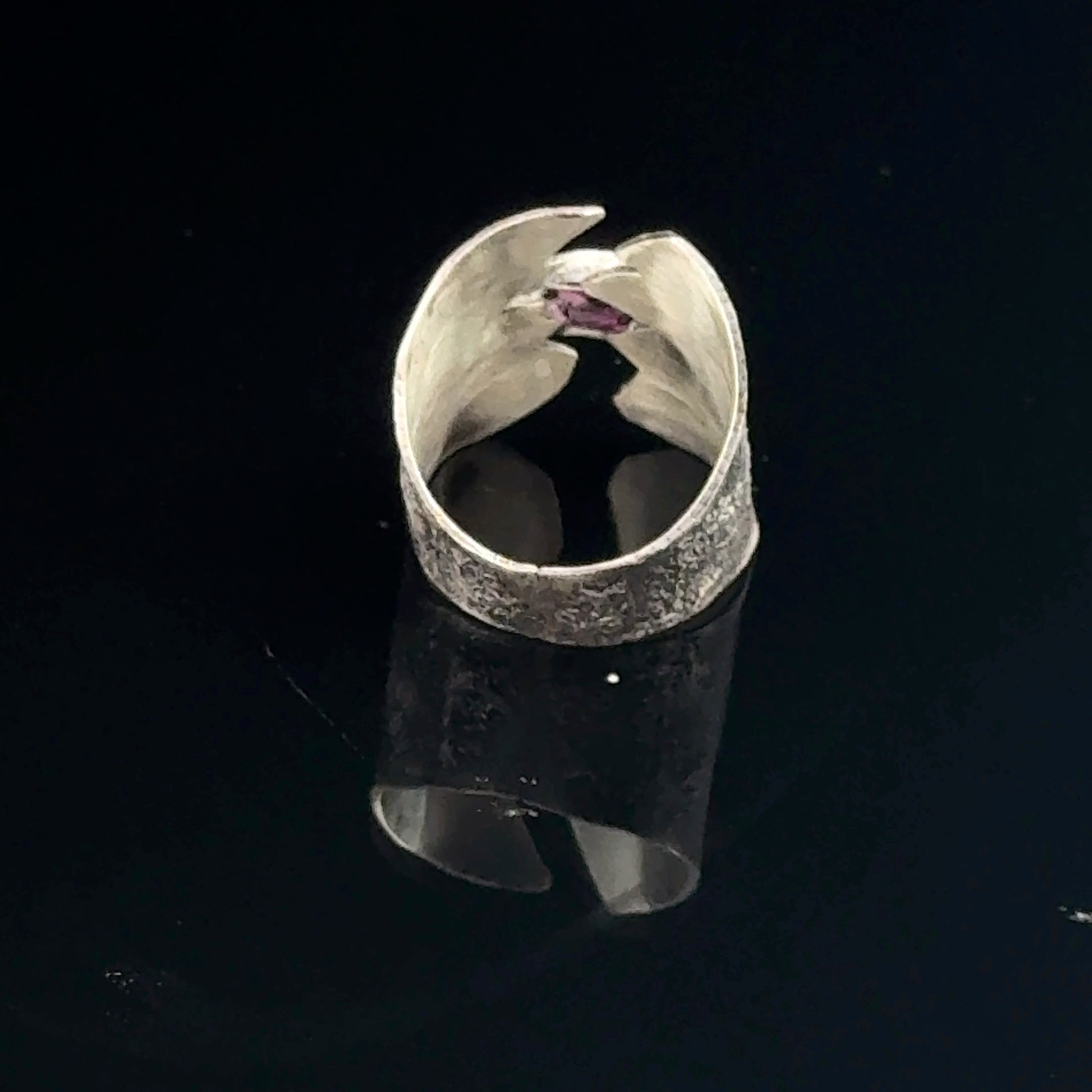 Sterling silver shield ring with almandine garnet center (size 6.5) on a black background backside view. 