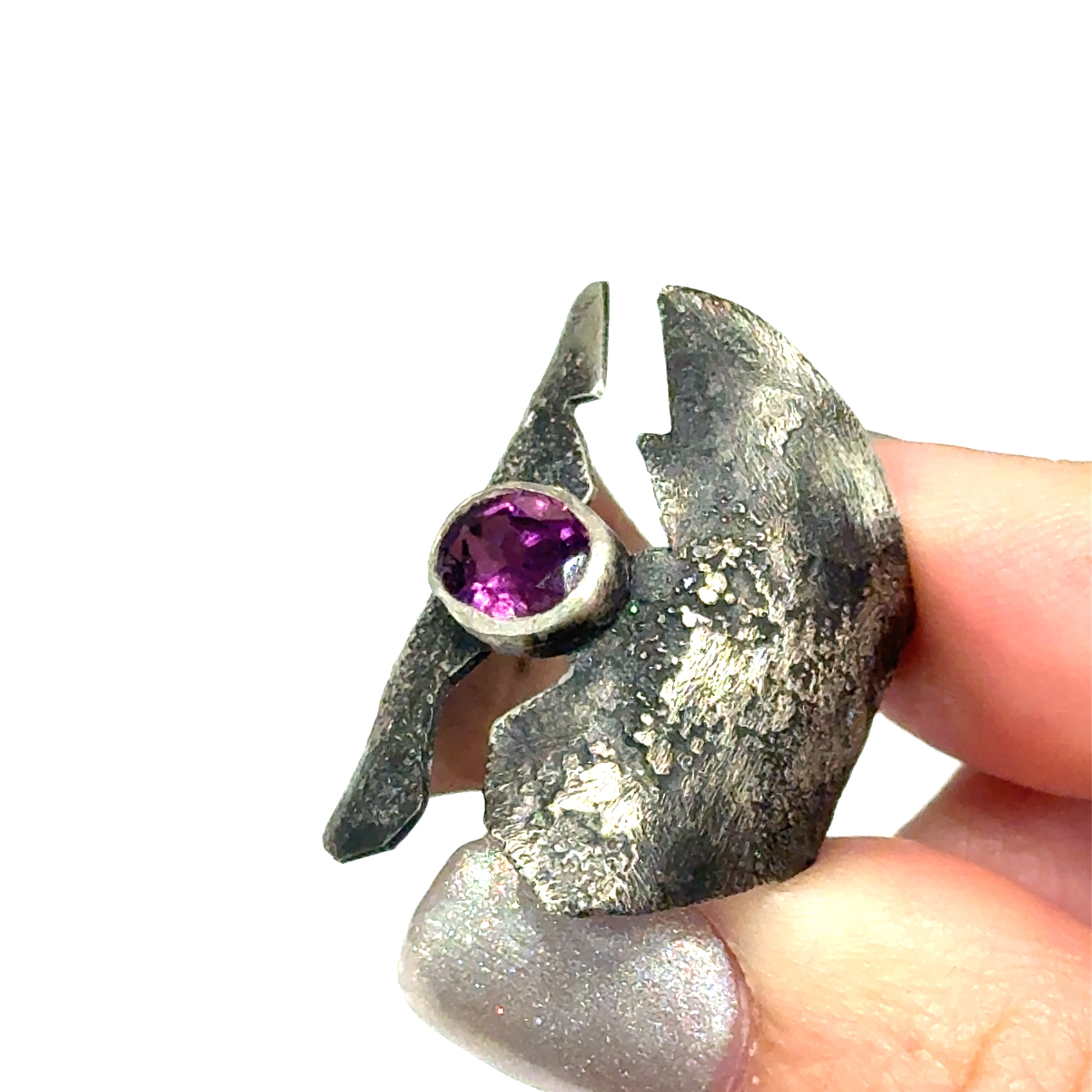 Sterling silver shield ring with almandine garnet center (size 6.5) on a white background, in models hand front, view. 