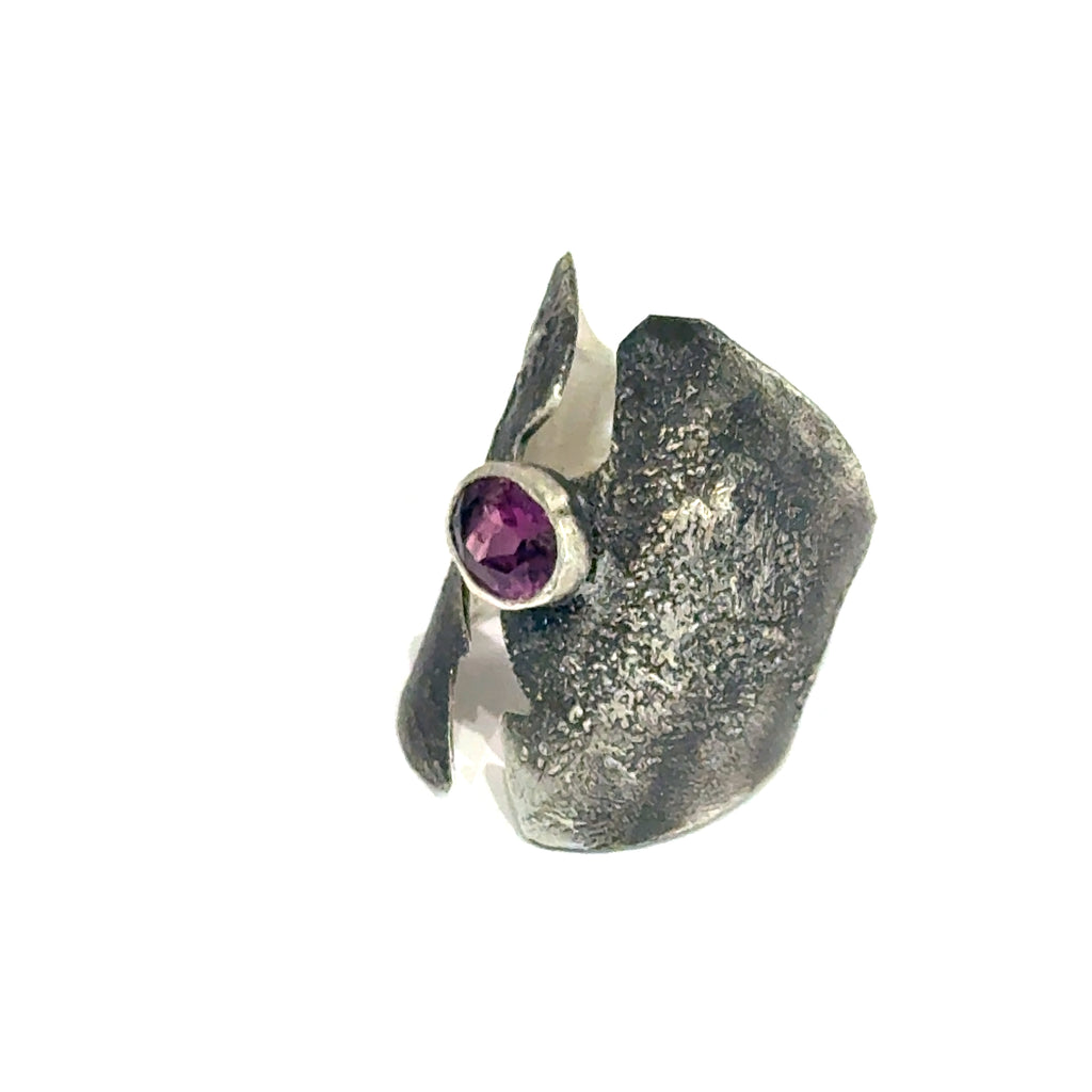 Sterling silver shield ring with almandine garnet center (size 6.5) on a white background, left angle  front, overview. 