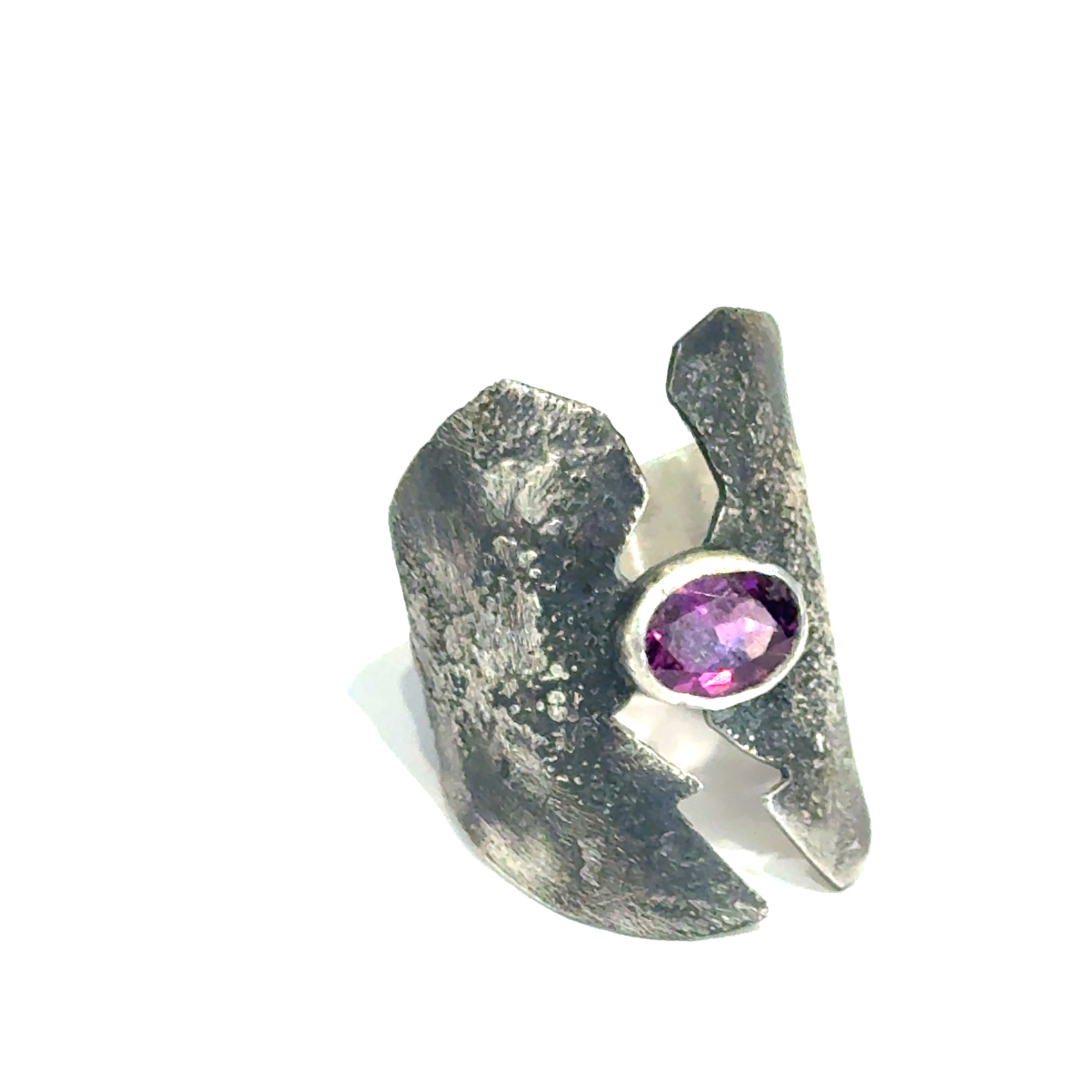 Sterling silver shield ring with almandine garnet center (size 6.5) on a white background, right angle  front, overview. 