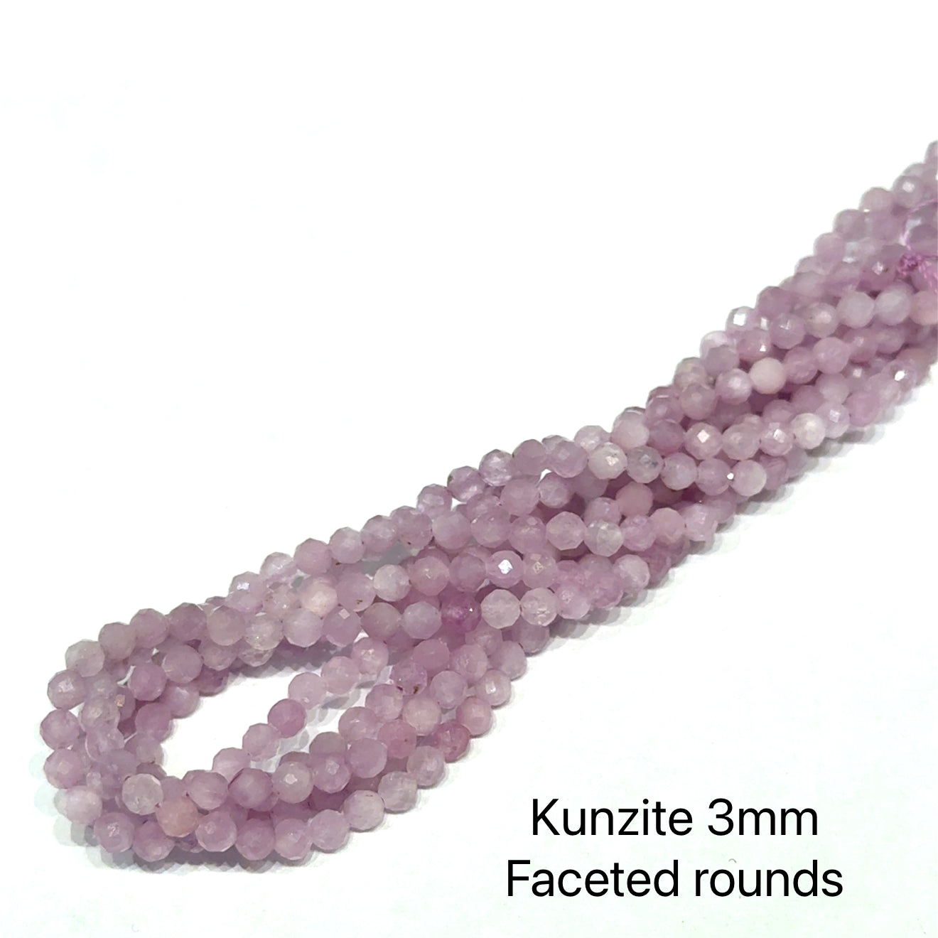 Strand of Kunzite 3mm faceted rounds on a white background, front view.