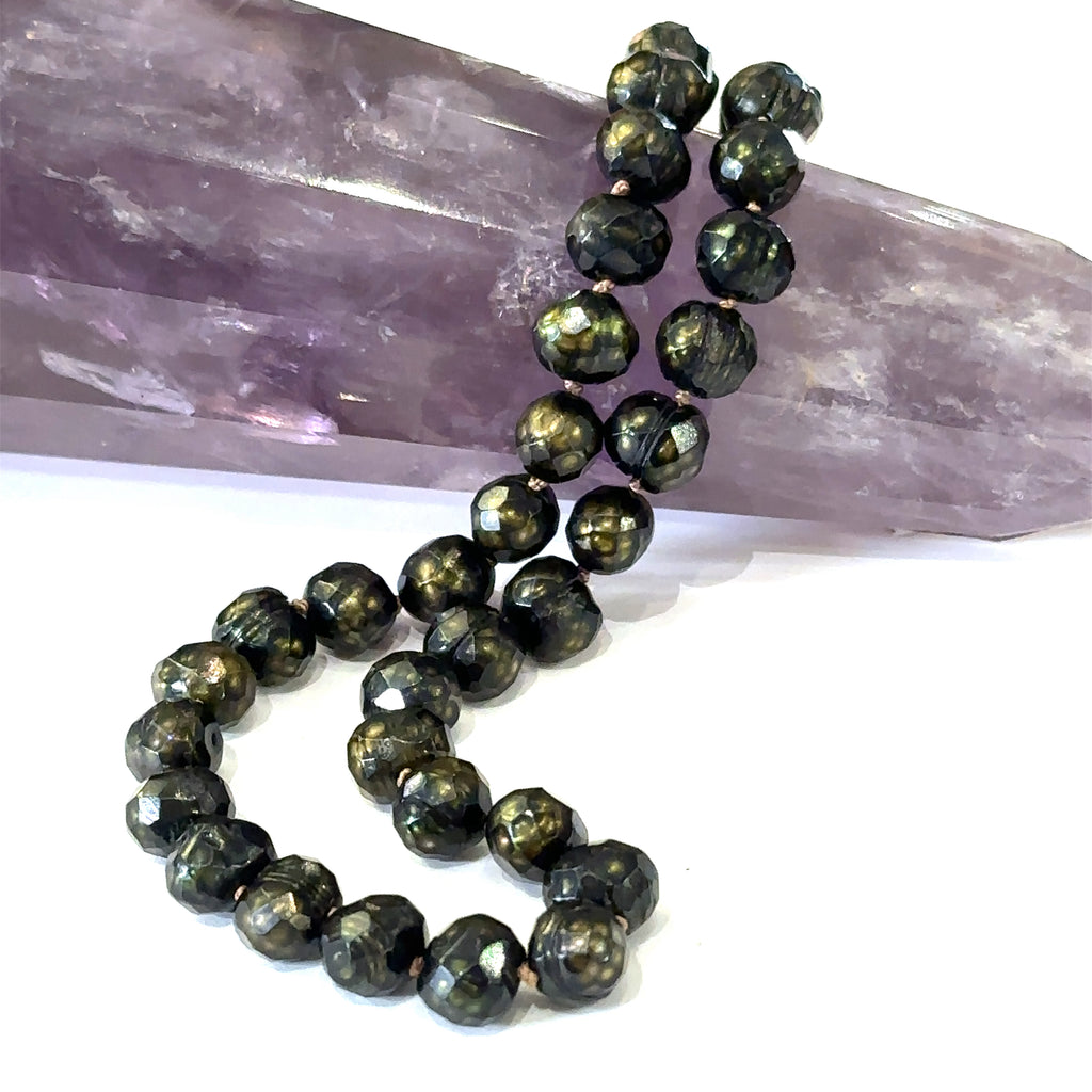Stunning black faceted freshwater pearl necklace with silk knotting cord and gold‑filled lobster clasp on white long view 