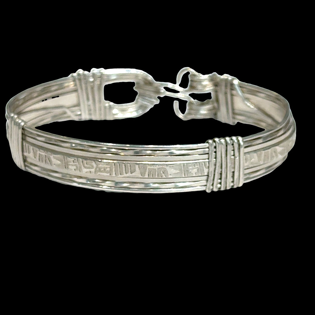 Style #3 Sterling silver bangle with twisted and straight wire featuring line-designed centerpiece showing elegant classic design, on a back background, front view. 