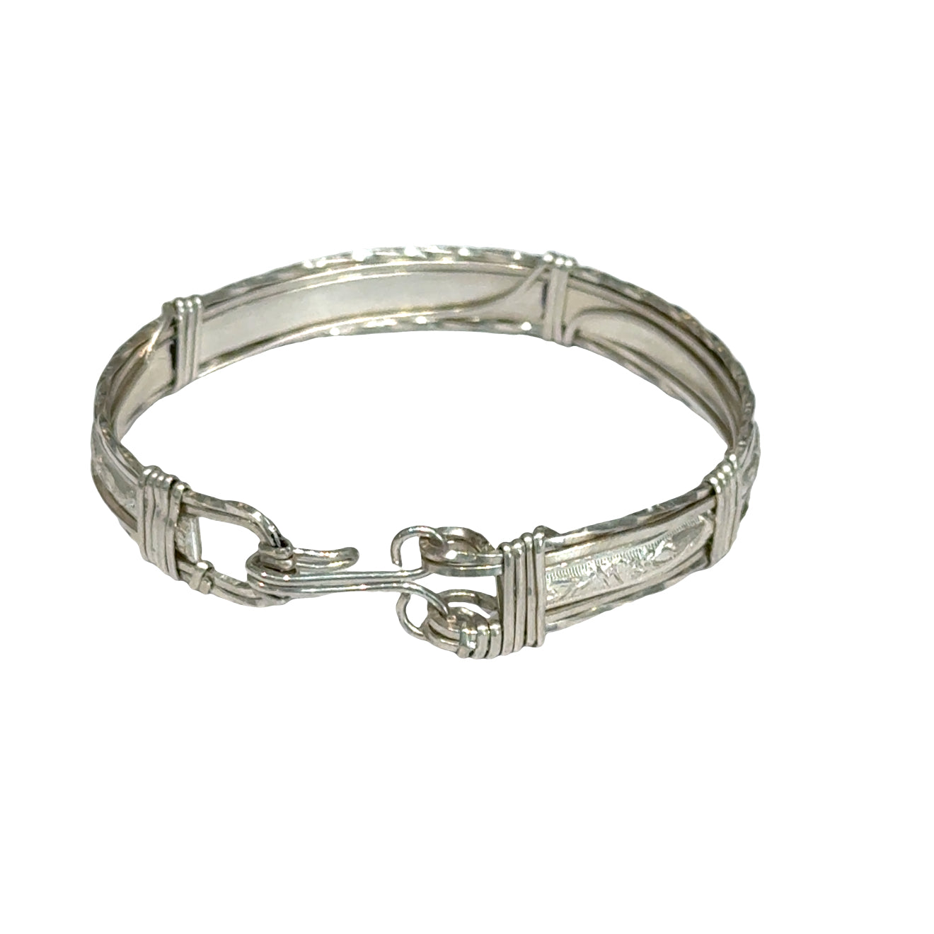 Style #3 Sterling silver bangle with twisted and straight wire featuring line-designed centerpiece showing elegant classic design, on a white background, back close up view. 