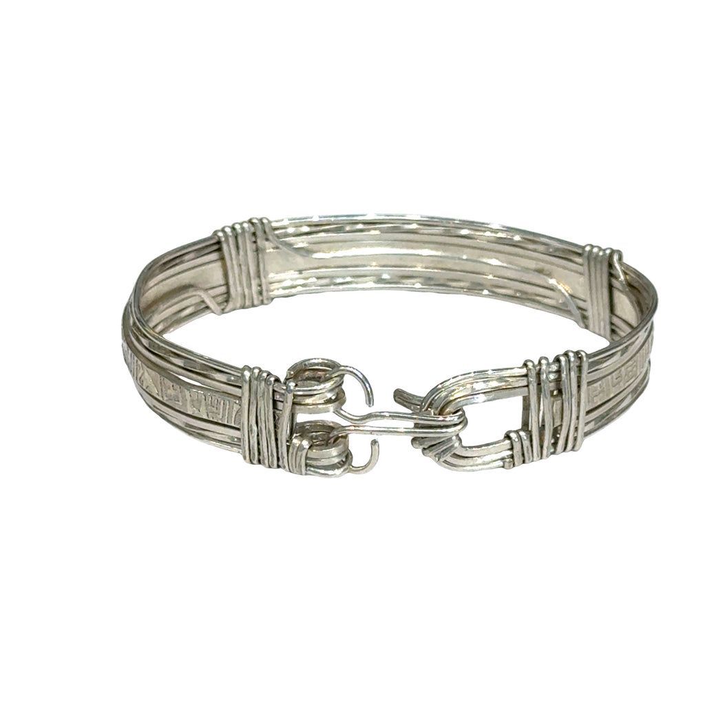 Style #3 Sterling silver bangle with twisted and straight wire featuring line-designed centerpiece showing elegant classic design, on a white background, back view. 