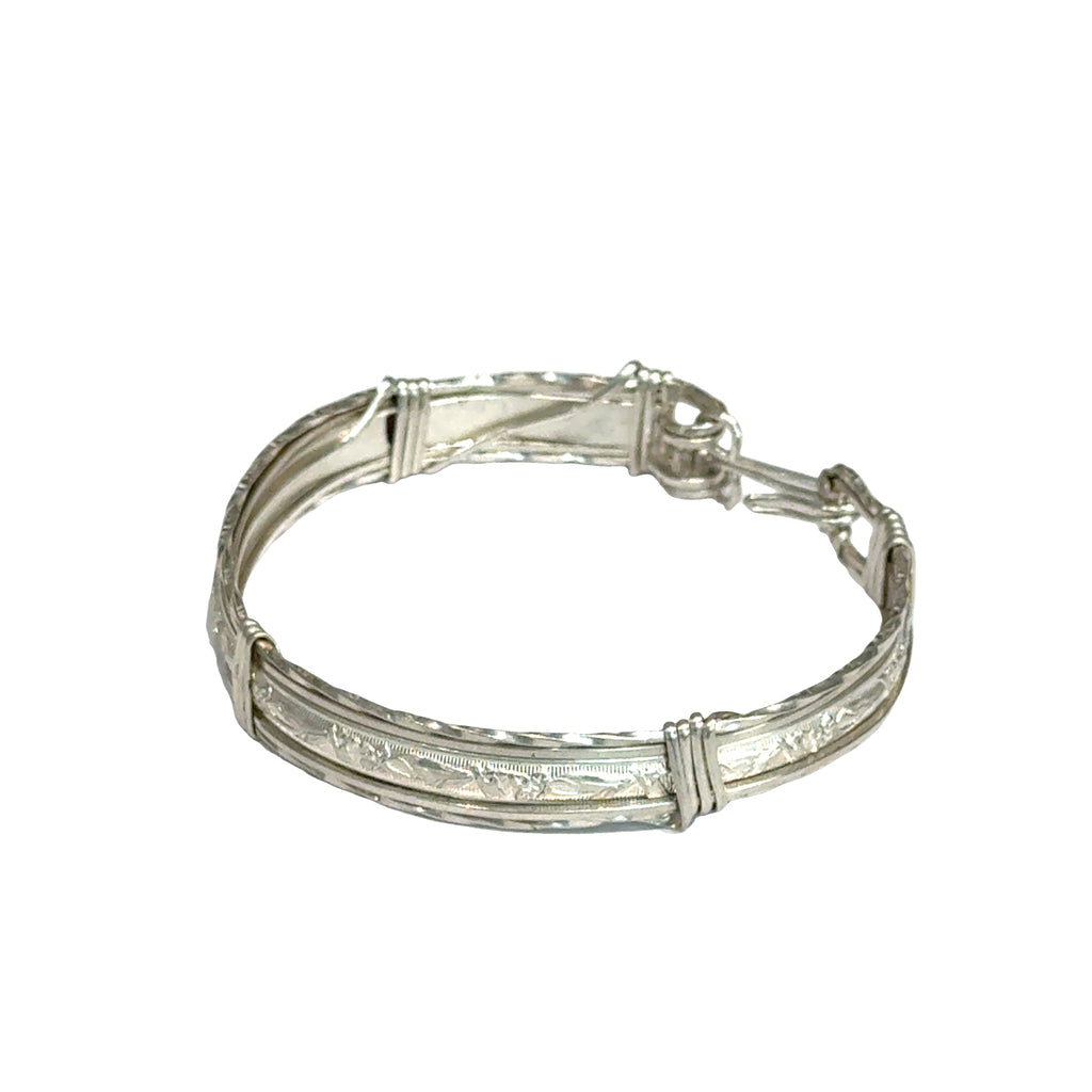 Style #3 Sterling silver bangle with twisted and straight wire featuring line-designed centerpiece showing elegant classic design, on a white background, front close up view. 