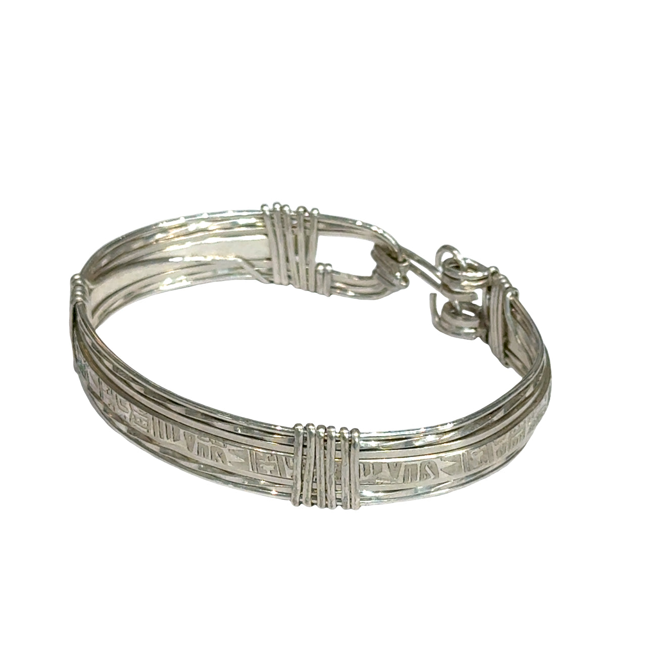 Style #3 Sterling silver bangle with twisted and straight wire featuring line-designed centerpiece showing elegant classic design, on a white background, front left angle view. 