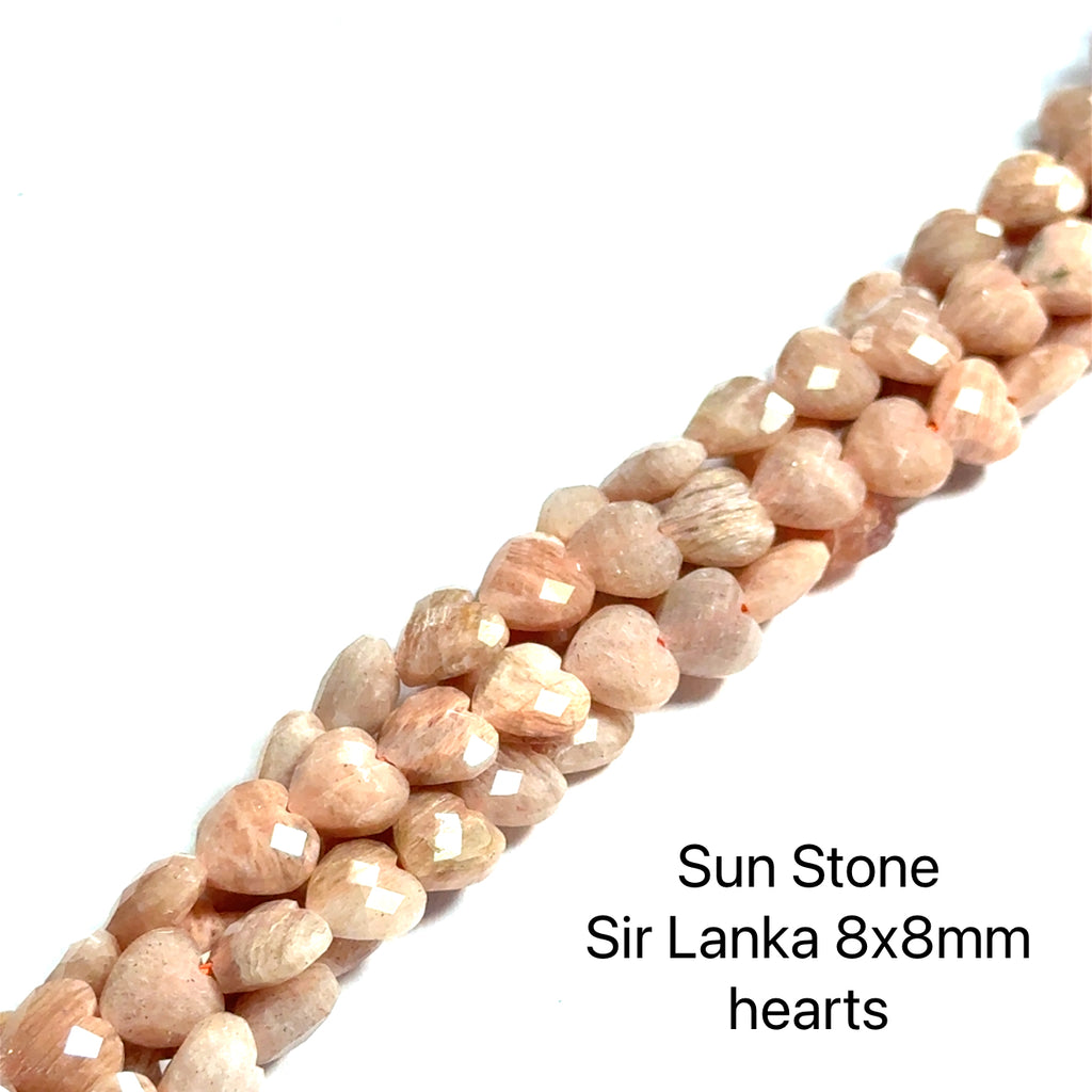 Sunstone 8x8mm faceted hearts gemstone strand on a white background, front overview. 