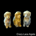 Three  Crazy Lace Jasper hound Dog gemstone carving on Black background, front view.