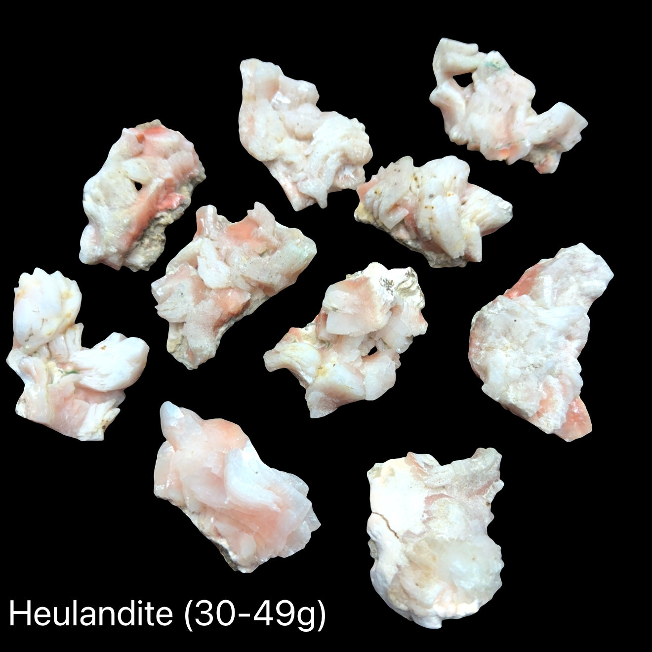 Three Ethically sourced Siberian heulandite specimen for heart chakra healing (30-49g) on a black background, front overview. 