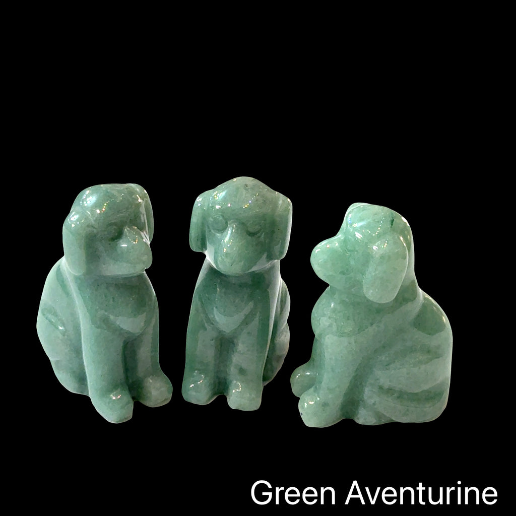 Three  Green Aventurine hound Dog gemstone carving on Black background, front view.