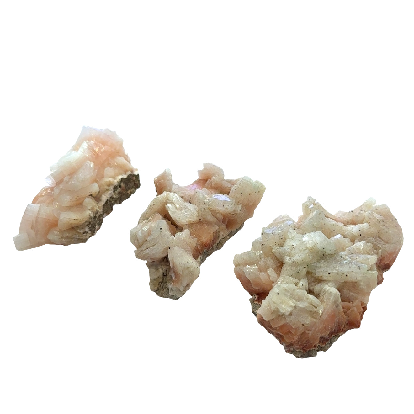 Three Natural heulandite zeolite mineral showing layered crystal blade formation on a white background, front overview. 