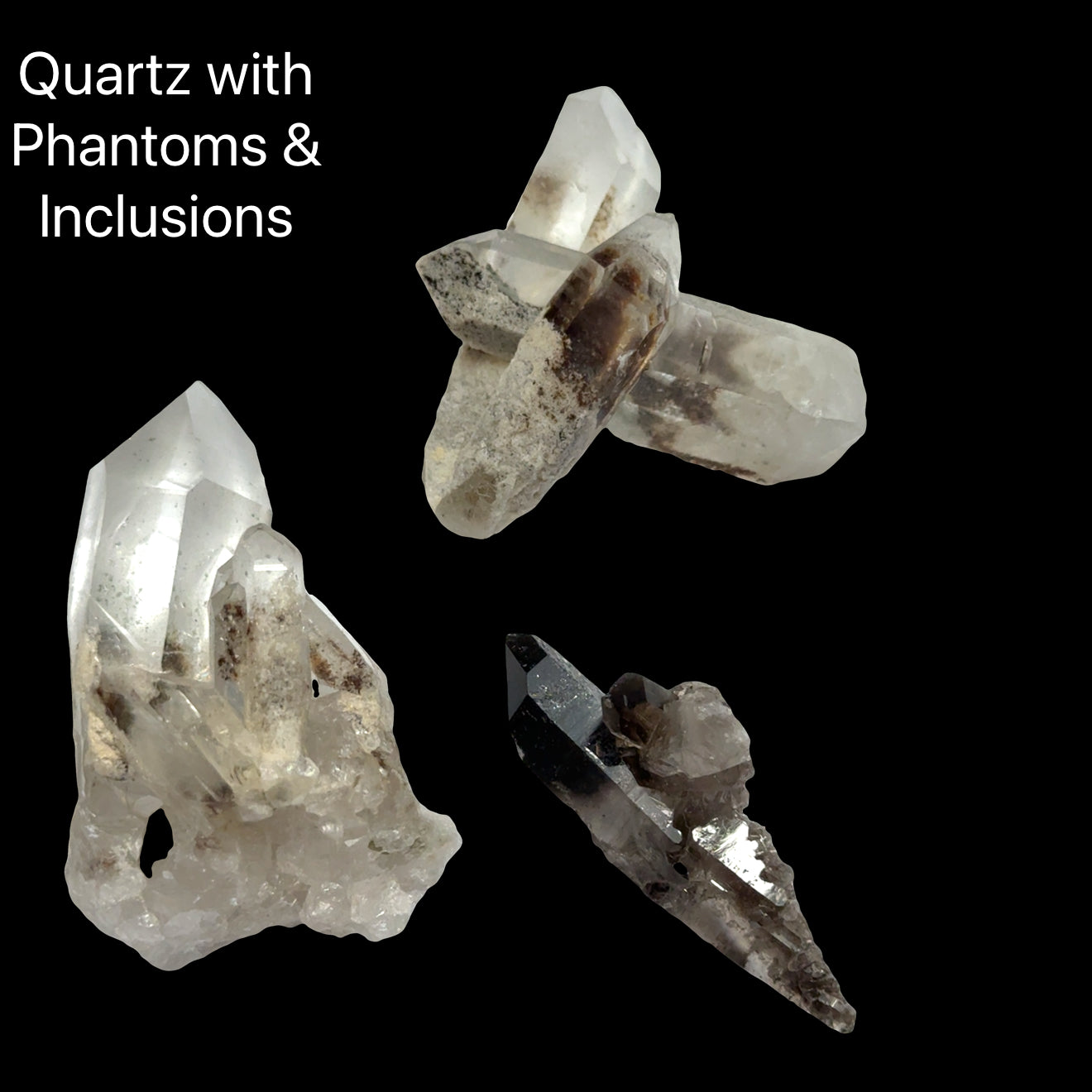 Three Quartz crystals with phantoms and inclusions on a black background, front view.