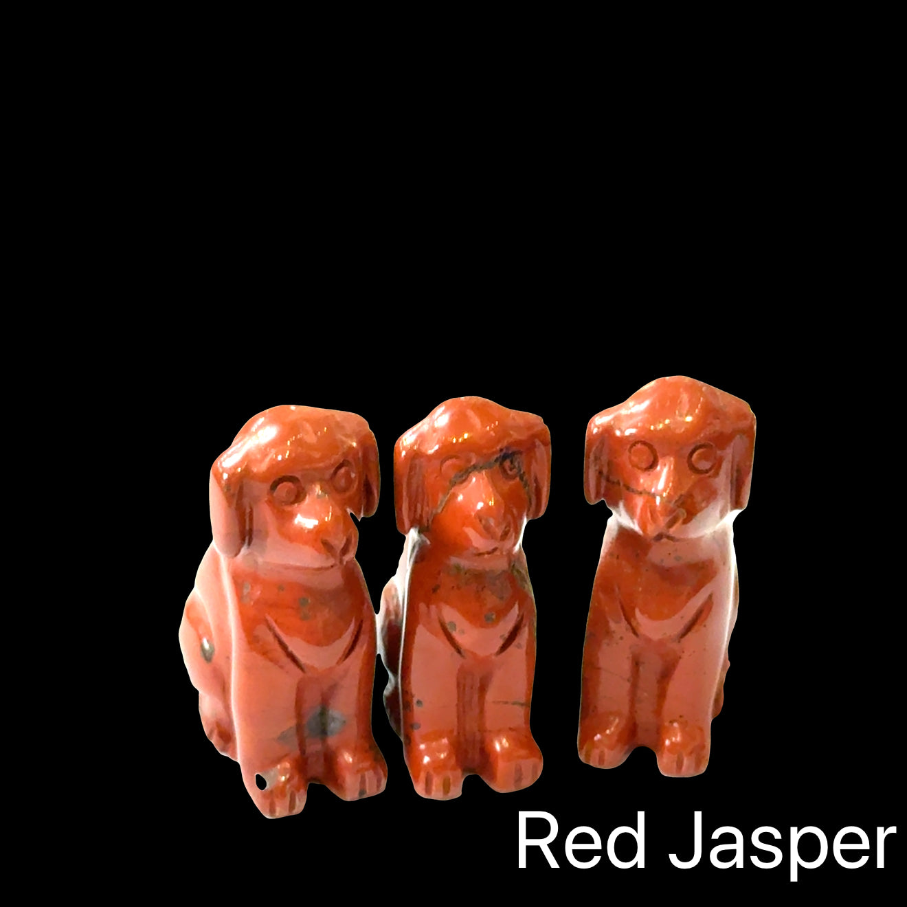 Three  Red Jasper hound Dog gemstone carving on Black background, front view.