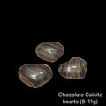 Three chocolate calcite hearts (8-11g) on a black background, front view.