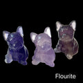 Three large Fluorite Bull Dogs gemstone carving on black background, front view. 