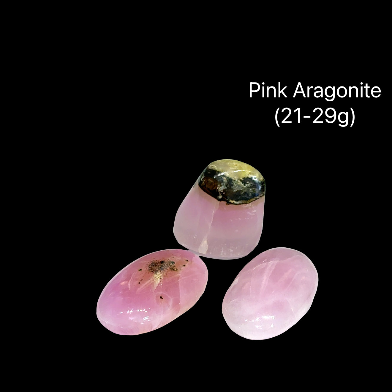Three pink aragonite stones on a black background with text indicating weight range (21-29g), front view.
