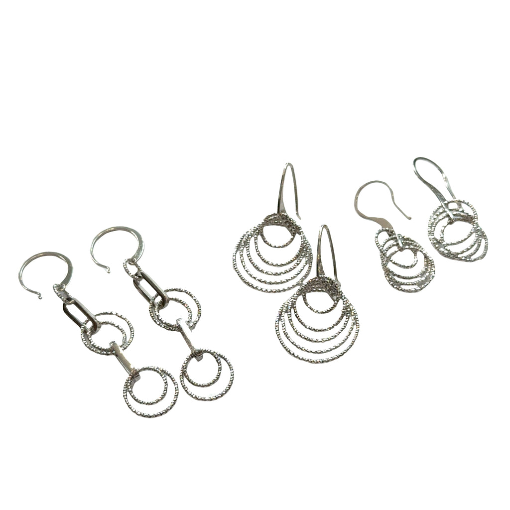 Three set of three different style diamond  cut Multi-circle sterling silver dangle earrings showing sparkle and movement on a white background, front hanging overview.