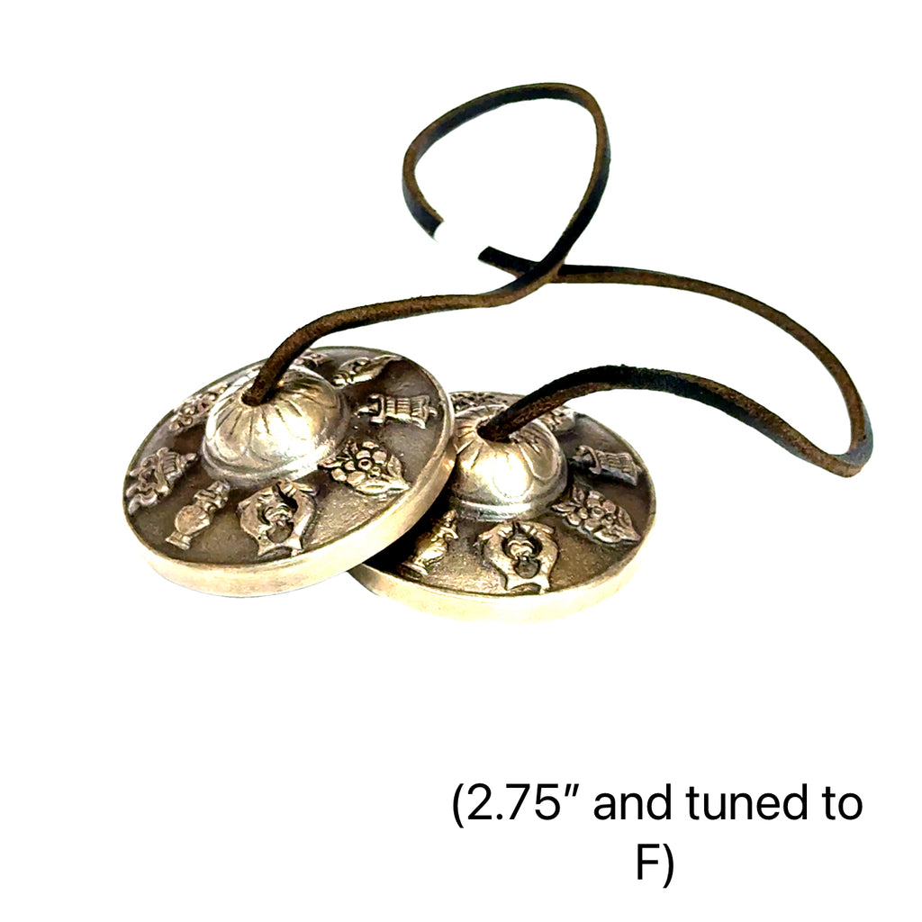 Tinsiga cymbals crafted by certified sound therapist for meditation and energy clearing (2.75'' and tuned to F)  on white overview